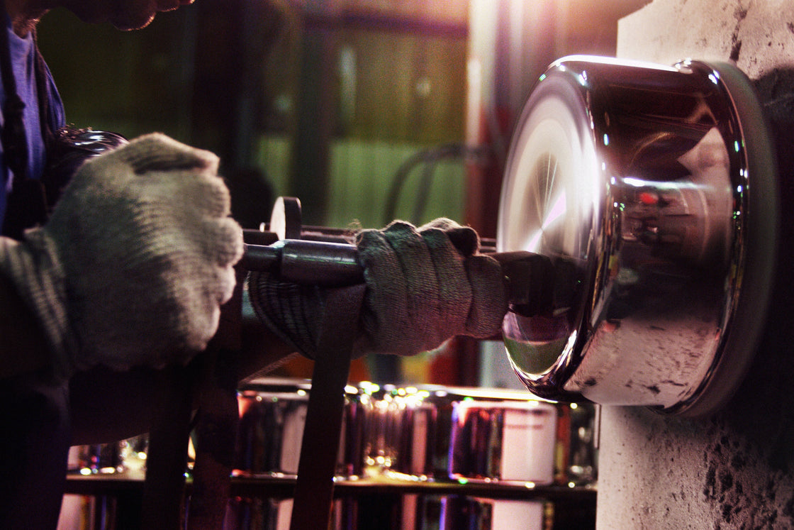 Hand-finishing the spiral pattern on a pan in the Clarksville factory