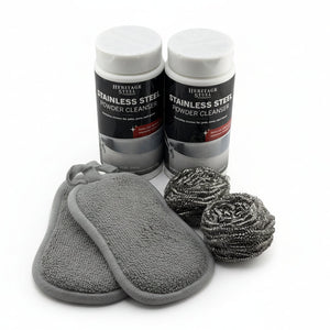 Two bottles of Heritage Steel Stainless Steel Powder Cleanser with cleaning pads and scrubbers on a white background.